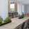 a room with a table chairs and plants
