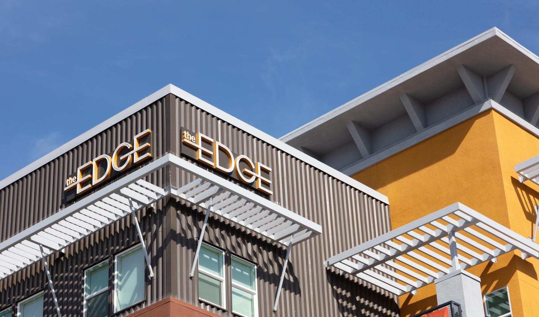 The essence of exceptional living a building with a sign on it